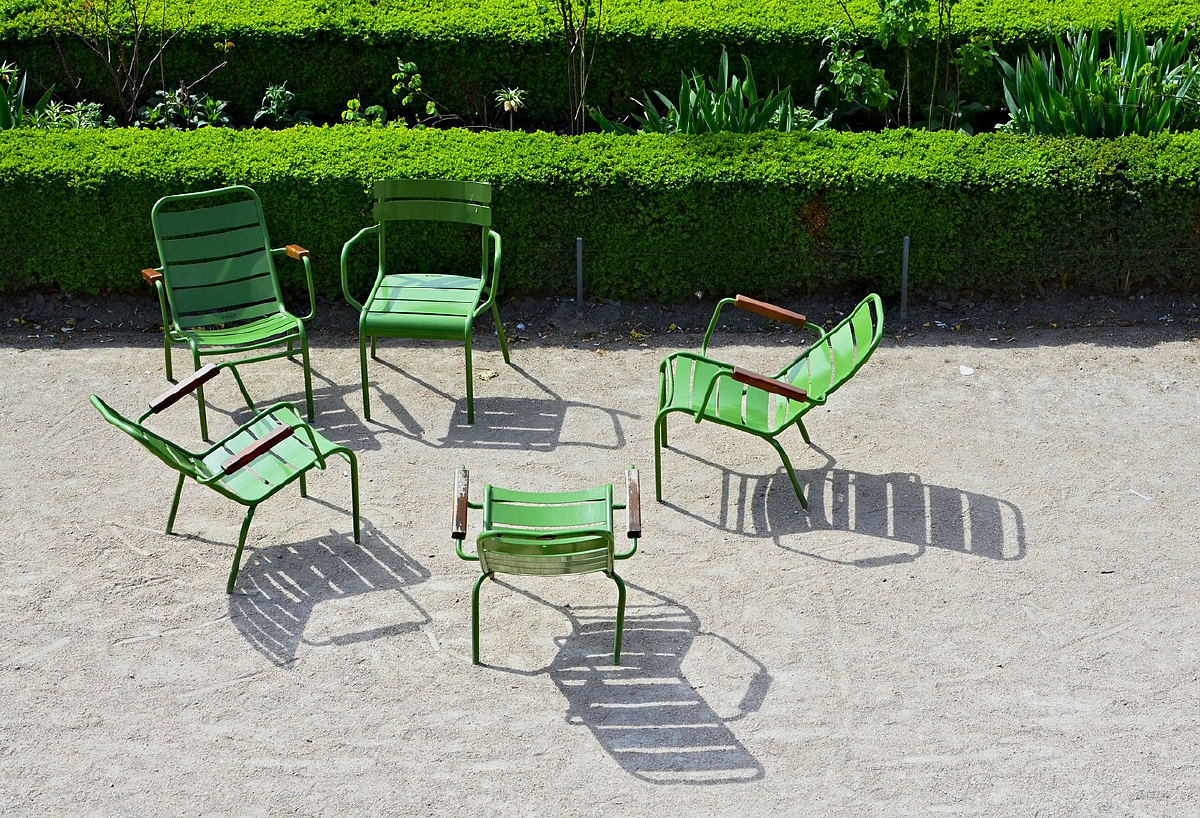 Green chairs around a pond in the Tuileries Garden